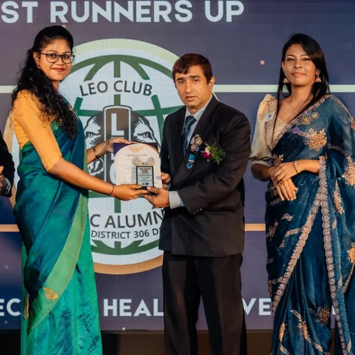 A member receiving the club's runners-up award plaque on stage